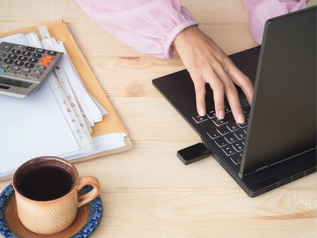 A person reviewing financial documents at a desk, with a calculator and laptop nearby, symbolizing careful financial planning and loan management.
