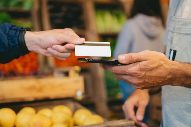 A close-up shot of an EBT card being used at a grocery store checkout. The cashier is scanning the card, and various food items are visible on the conveyor belt. The focus is on the card and the transaction process.