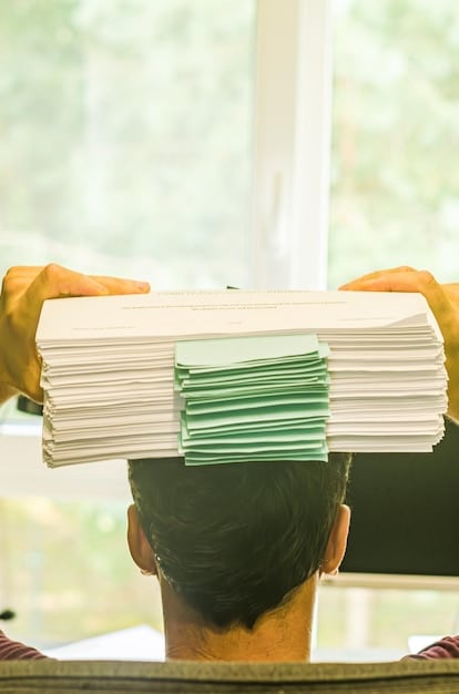 A hand holding a stack of documents, including a lease agreement, pay stubs, and utility bills. The background is slightly blurred, focusing the attention on the paperwork.